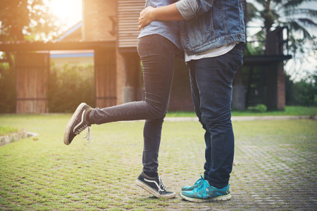 Hipster couple in love kissing in summer sun light. Love kiss standing.の写真素材