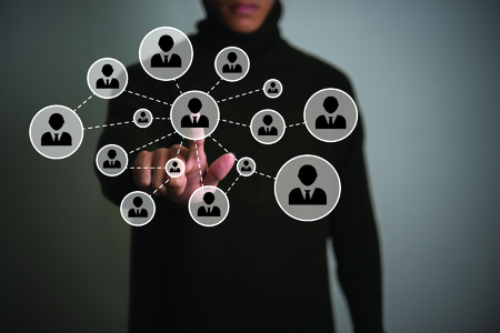 Businessman pressing people icon network button on modern digital display. Multimedia and technology concept.の写真素材