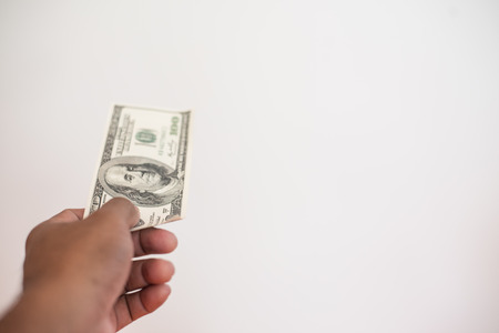 Man hand with money isolated on a white background.の写真素材