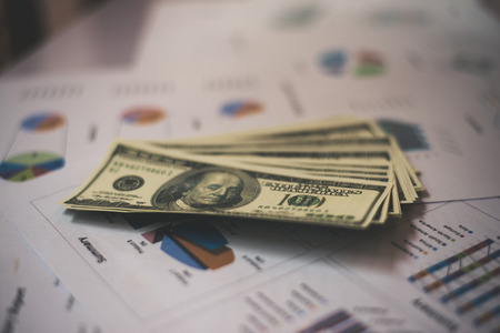 Business documents on workplace with dollar usd money on background.の写真素材