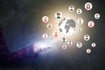 Modern communication technology media icons on mobile phone screen. Woman holding smartphone in hand.の写真素材