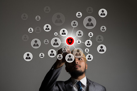 Young businessman pointing  digital people icon network application in his hand.の写真素材