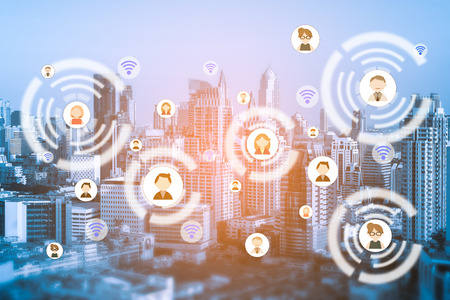 People icons network and communication concept. Double exposure of connecting people icons with cityscape at night background.の写真素材