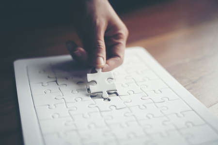 Hand holding jigsaw puzzles, Business partnership concept.