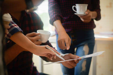 Startup business people group meeting. People group sitting on conference together and making notes. hands pointing at business document during discussion at meeting.の写真素材