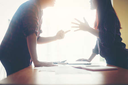 Serious businessman explaining business planning to business woman.の写真素材
