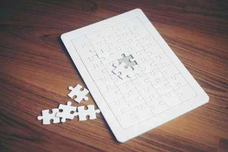 Jigsaw puzzles on wood background, Business partnership concept.の写真素材