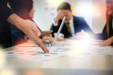 Startup business people group meeting. People group sitting on conference together and making notes. hands pointing at business document during discussion at meeting.の写真素材