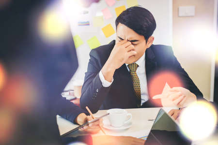 Serious businessman working on documents looking data and planning business on table.の写真素材