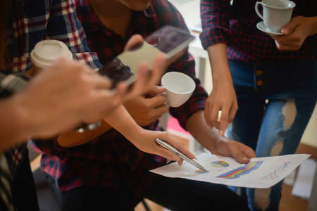 Startup business people group meeting. People group sitting on conference together and making notes. hands pointing at business document during discussion at meeting.の写真素材