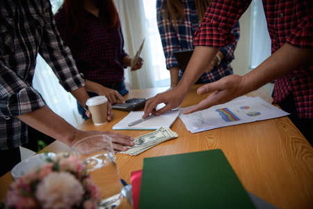Startup business people group meeting. People group sitting on conference together and making notes. hands pointing at business document during discussion at meeting.の写真素材