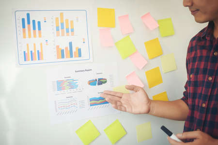 Close-up hand present business graph chart on whiteboard. planning concept.