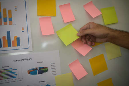 Close-up hand present business graph chart on whiteboard. planning concept.の写真素材