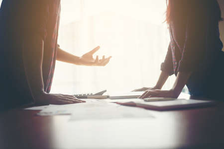 Serious businessman explaining business planning to business woman.