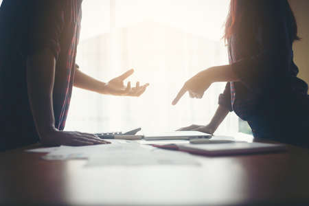 Serious businessman explaining business planning to business woman.の写真素材
