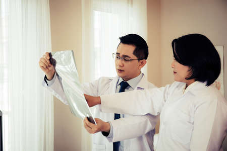 Close up of doctor holding x-ray, x-ray film of patient at hospital.の写真素材