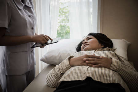 Young Nurse take care for elderly patients during hospital admission.の写真素材