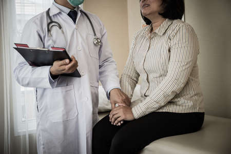 Doctor assisted the patient during his health check-up at the hospital.の写真素材