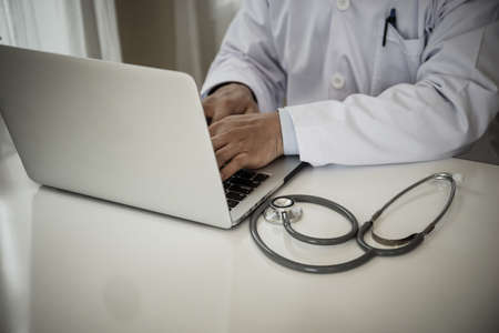 Close up of Medical doctor working with laptop in the office.の写真素材