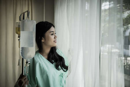 Female patient standing in the room in hospital. Hope concept.の写真素材
