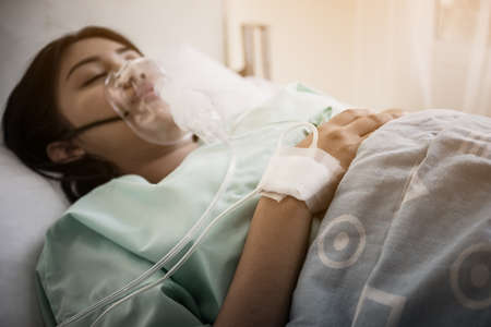 Patients suffering from unconsciousness during treatment, resting in patient bed.の写真素材