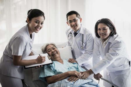 Medical Team Meeting With senior patient In Hospital Roomの写真素材