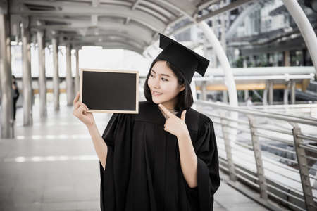 Graduate Woman Holding with blackboard.の写真素材