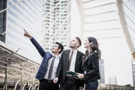 Image of business partners discussing documents and ideas at meeting together outsideの写真素材