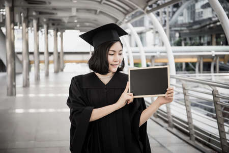 Graduate Woman Holding with blackboard.の写真素材