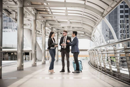 Team of business colleagues meeting while walking in a modern city to go travelling. Business travel concept.の写真素材