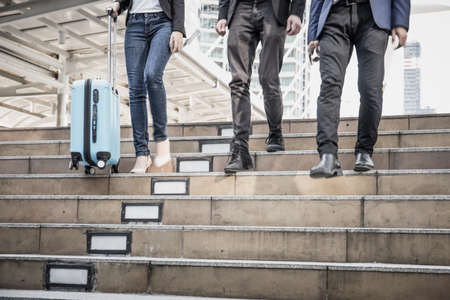 Business people walking down the stairs. On the way back from work quickly.の写真素材