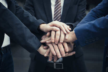 Group of Business Partners Team with hands together. People with business team stacking hands together.の写真素材