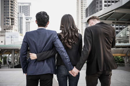 Image concept of a marital infidelity. Business people working together and man try to infidelity his couple.の写真素材