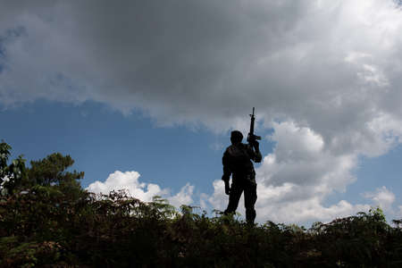 Military silhouettes of soldiers ready his weapon.の写真素材