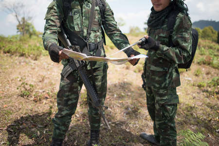 Soldier ready his weapon and View map  in the forestの写真素材