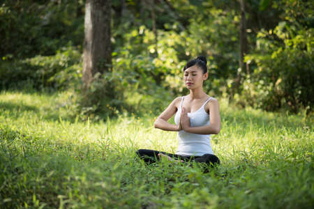 woman playing yoga garden field weekend holiday lifestyle park outdoor nature background.の写真素材