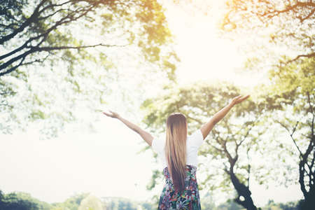 Happy woman in the park summer with open hands , Relax time and happinessの写真素材