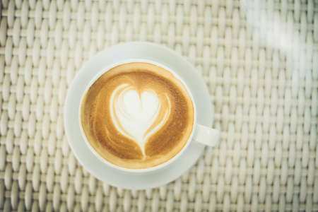 Latte art coffee with heart-shaped milk foamの写真素材