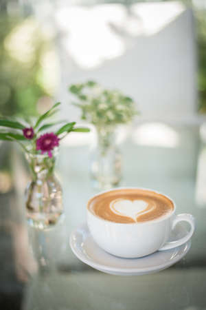 Latte art coffee with heart-shaped milk foamの写真素材