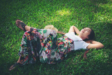 Young woman lying down on grass. relax time.の写真素材