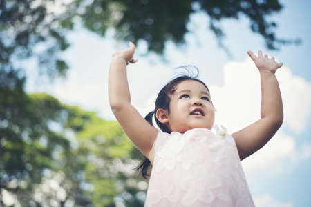 Portrait of little girl smiling showing happy in the parkの写真素材