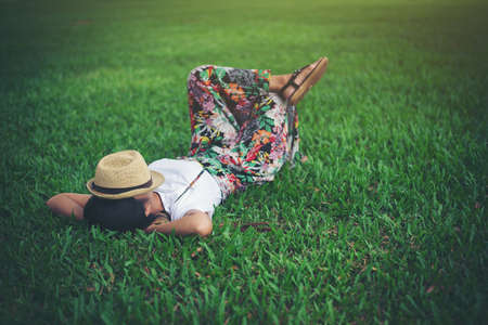 Young woman lying down on grass. relax time.