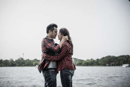 Happy couple. Young couple in love standing on
 Riverside  and smiling. Love storyの写真素材