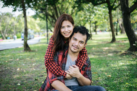 Romantic Young Couple Sitting In Gardenの写真素材