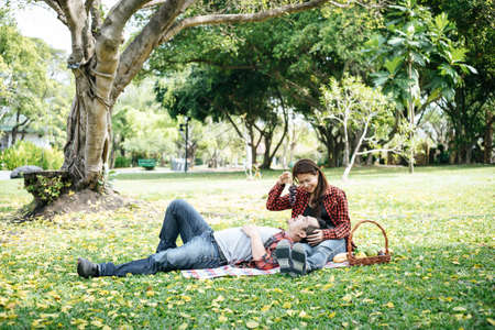 Romantic Young Couple Sitting In Gardenの写真素材