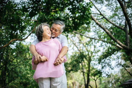 Happy senior couple in the parkの写真素材