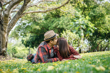 Romantic Young Couple Sitting In Gardenの写真素材