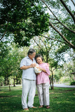 Happy senior couple in the parkの写真素材