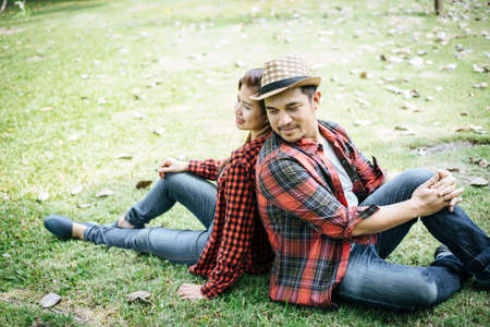 Romantic Young Couple Sitting In Gardenの写真素材
