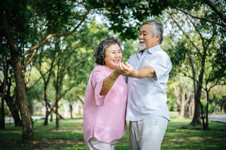 Happy senior couple in the parkの写真素材